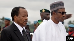 President of Cameroon Paul Biya, left, walks with his Nigerian counterpart, Muhammadu Buhari, following his arrival at the airport in Yaounde, July 29, 2015. 
