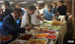 Uighur Muslims share a meal as part of Eid festivities in Falls Church, Virginia, Aug. 21, 2018. (B. Gallo/VOA)