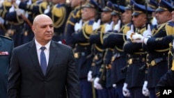 Newly-elected Lebanese President Joseph Aoun reviews the honor guard upon his arrival at the Lebanese Parliament to be sworn in, in Beirut, Lebanon, Jan. 9, 2025. 