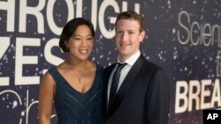 FILE - Priscilla Chan and Mark Zuckerberg are shown in Mountain View, Calif., Nov. 9, 2014. Mark Zuckerberg plans to take two months' paternity leave when his child is born.