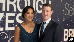 FILE - Priscilla Chan and Mark Zuckerberg are shown in Mountain View, Calif., Nov. 9, 2014. 