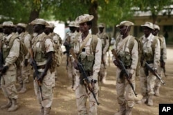 FILE - Chadian troops participate in the closing ceremony of operation Flintlock in an army base in N'djamena, Chad, March 9, 2015.