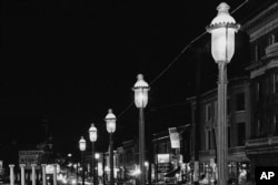 FILE - Gas lamps illuminate St. Louis' Gaslight Square on April 2, 1962. "Gaslighting" — mind manipulating, grossly misleading, downright deceitful — is Merriam-Webster's word of 2022. (AP Photo/JMH, File)
