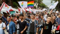 Same-sex marriage supporters cheer after the Constitutional Court ruled in favor of same-sex marriage outside the Legislative Yuan in Taipei, Taiwan, May 24, 2017. Taiwan's Constitutional Court ruled in favor of same-sex marriage Wednesday, making the island the first place in Asia to recognize gay unions. 