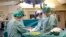 FILE - In this April 4, 2012 photo made available by the University of Goteborg in Sweden, the Swedish research team practices before the operations to transplant wombs at the Sahlgrenska Hospital in Goteborg, Sweden. 