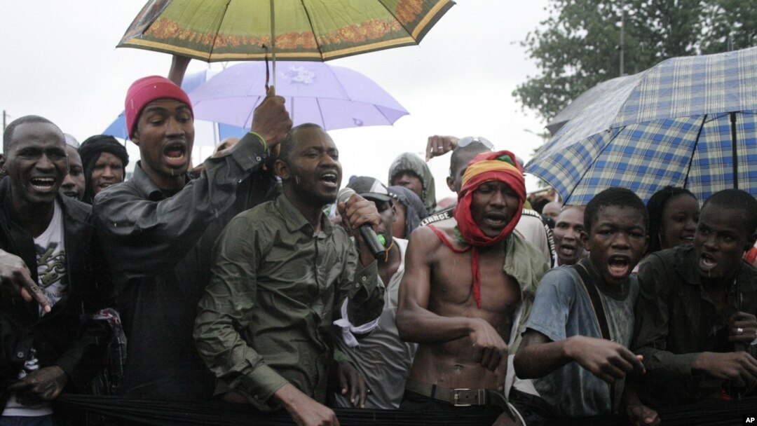 People originally from Mali's north protest in the rain against the Islamist takeover of northern Mali, in the capital, Bamako, Mali, July 4, 2012.