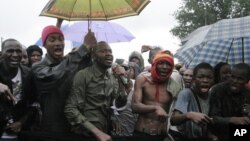 People originally from Mali's north protest in the rain against the Islamist takeover of northern Mali, in the capital, Bamako, Mali, July 4, 2012.