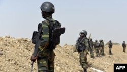 FILE - Cameroonian soldiers patrol in the Cameroonian town of Fotokol, on the border with Nigeria, after clashes between Cameroonian troops and Nigeria-based Boko Haram insurgents, Feb. 17, 2015.