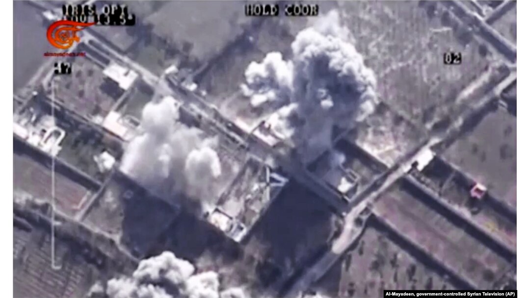 This image made from video of drone footage allegedly showing Syrian army airstrikes targeting Zahran Allouch, the head of the Army of Islam group near Damascus, Syria, Dec. 25, 2015.