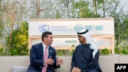 FILE - This handout picture provided by the UAE Presidential Court shows UAE President Sheikh Mohamed bin Zayed al-Nahyan(C) and President of Paraguay Santiago Pena meeting in the EXPO city during the COP28 United Nations climate summit in Dubai on November 30, 2023.