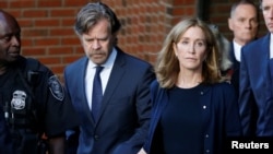 Actress Felicity Huffman leaves the federal courthouse with her husband William H. Macy, after being sentenced in connection with a nationwide college admissions cheating scheme in Boston, Massachusetts, Sept. 13, 2019. 