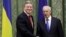 European Commissioner for Enlargement and European Neighborhood Policy Stefan Fuele, left, shakes hands with Ukraine Prime Minister Mykola Azarov during their meeting in Kiev, Ukraine, February 7, 2013.