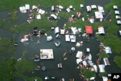 In this photo provided by the Malacanang Presidential Communications Office, structures are left damaged by Tropical Storm Trami in Laguna de Bay, Laguna province, Philippines, on Oct. 25, 2024.