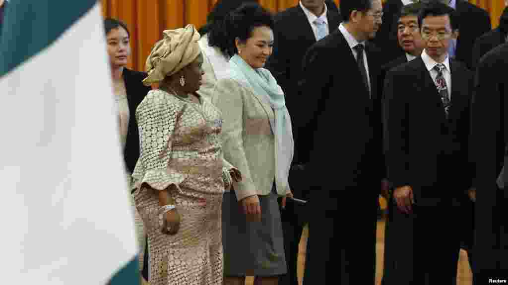 Chinese President Xi Jinping's wife Peng Liyuan and First Lady Patience Jonathan attend a welcome ceremony in Beijing, July 2013.