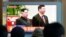 FILE- People watch a TV screen showing file footage of North Korean leader Kim Jong Un and Chinese President Xi Jinping, right, during a news program at the Seoul Railway Station in Seoul, South Korea, Jan. 8, 2019. 