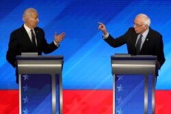 Democratic presidential candidates former Vice President Joe Biden, left, and Sen. Bernie Sanders (I-VT) participate in the Democratic presidential primary debate at St. Anselm College, Feb. 7, 2020, in Manchester, N.H.