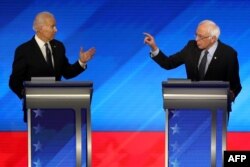 Democratic presidential candidates former Vice President Joe Biden, left, and Sen. Bernie Sanders (I-VT) participate in the Democratic presidential primary debate at St. Anselm College, Feb. 7, 2020, in Manchester, N.H.