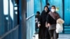 FILE - Women wearing protective masks amid the coronavirus pandemic walk in Iran's capital, Tehran, April 5, 2021.
