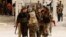 FILE - Free Syrian Army fighters carry the body of a fellow fighter who was killed during what FSA rebels say were clashes with forces loyal to President Bashar al-Assad near Aleppo International airport.