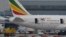 Emergency services attend to a Boeing 787 Dreamliner, operated by Ethiopian Airlines, after it caught fire at Britain's Heathrow airport in west London, July 12, 2013. 