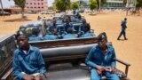 FILE - Police officers sit on the back of pickup trucks as the prepare to patrol the streets of Juba, South Sudan, April 9, 2020. 