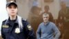 Founder of the Baring Vostok private equity group Michael Calvey, who was detained on suspicion of fraud, sits inside a defendants' cage as he attends a court hearing in Moscow, Feb. 15, 2019.