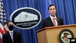 Acting Assistant Attorney General Brian Rabbitt, of the Justice Department's Criminal Division, and other officials speak at the Justice Department in Washington, Oct. 22, 2020.