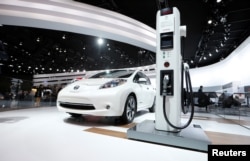 FILE: A Nissan Leaf electric car is displayed next to a charging stand at the North American International Auto Show in Detroit, Jan.12, 2016.