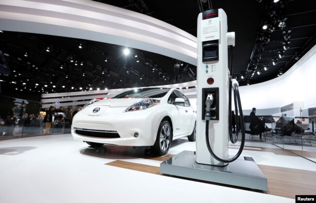 FILE: A Nissan Leaf electric car is displayed next to a charging stand at the North American International Auto Show in Detroit, Jan.12, 2016.
