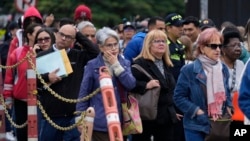 People stand outside the U.S. Embassy in Bogota, Colombia, Jan. 27, 2025, where they were notified their visa appointments were canceled.