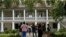 FILE - Visitors walk outside the main plantation house at the Whitney Plantation in Edgard, La., July 14, 2017.