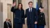 French President Emmanuel Macron stands next to U.S. Vice President Kamala Harris as she waves before a bilateral meeting at Élysée Palace in Paris, France, Nov. 10, 2021. 