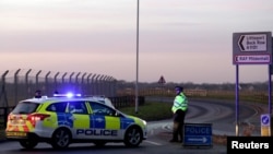 British police stand guard at the entrance to the U.S. Air Force base at RAF Mildenhall, Britain, Dec. 18, 2017.