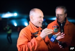 Solar Impulse 2 pilots Bertrand Piccard, left, and Andre Borschberg speak with reporters after their solar-powered plane landed at Moffett field in Mountain View, Calif., April 23, 2016.