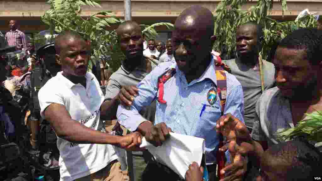 Kizza Besigye a entouré de quelques-uns de ses partisans avant d&rsquo;être arrêté par la police lors d&rsquo;une manifestation à Kampala, Ouganda, février 2016.