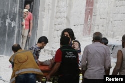 A man reacts while being carried on a stretcher after airstrikes on the rebel held al-Qaterji neighbourhood of Aleppo, Syria, September 21, 2016.