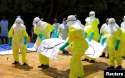 Congolese and World Health Organization officials wear protective suits as they participate in training to battle the Ebola virus near the town of Beni in North Kivu province of the Democratic Republic of the Congo, Aug. 11, 2018.