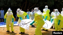 Congolese officials and the World Health Organization officials wear protective suits as they participate in a training against the Ebola virus near the town of Beni in North Kivu province of the Democratic Republic of Congo, Aug. 11, 2018. 