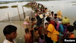 지난 7일 방글라데시 국경을 통과한 미얀마 로힝야족 난민들이 운하를 건너기 위해 배를 기다리고 있다.