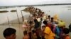 FILE - Rohingya refugees wait for boats to cross a canal after crossing the border through the Naf river in Teknaf, Bangladesh, Sept. 7, 2017.