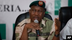 FILE - Brig. Gen. Chris Olukolade, Nigeria's top military spokesman, speaks during a press conference on the abducted school girls in Abuja, Nigeria, May 12, 2014.