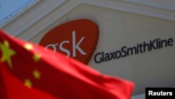 A Chinese national flag is seen in front of a GlaxoSmithKline office building in Shanghai, July 2013.