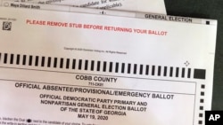 A Cobb County Ga., absentee ballot is seen Tuesday, May 5, 2020, in Kennesaw, Ga. Presidential Preference Primary, General Primary Election, Nonpartisan General Election, and Special Election. will be held June 9, 2020, in Georgia. (AP Photo/Mike…