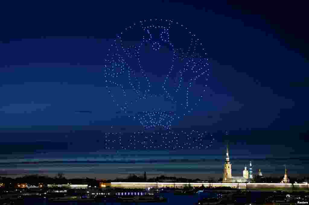 Drones forming a logo of the UEFA Euro Cup 2020 light up the sky over the Cathedral of St. Peter and St. Paul in Saint Petersburg, Russia May 2, 2021.