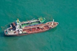FILE - This Japan Ministry of Defense photo shows North Korean-flagged tanker SAM JONG 2, bottom, alongside MYONG RYU 1, a vessel of unknown nationality, in the East China Sea, May 24, 2018, in a suspected illegal transferring of fuel.