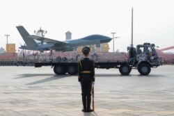 A military vehicle carrying an unmanned aerial vehicle travels past Tiananmen Square during the military parade marking the 70th founding anniversary of People's Republic of China in Beijing, Oct. 1, 2019.
