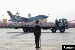 A military vehicle carrying an unmanned aerial vehicle travels past Tiananmen Square during the military parade marking the 70th founding anniversary of People's Republic of China in Beijing, Oct. 1, 2019.