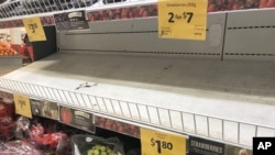 Empty shelves, normally stocked with strawberry punnets, are seen at a Coles Supermarket in Brisbane, Australia, Sept. 14, 2018.