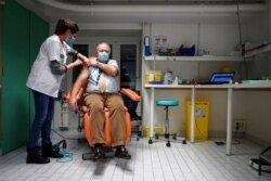 Dr. Christian Chidiac gets a Pfizer-BioNTech COVID-19 vaccine in La Croix-Rousse hospital, in Lyon, central France, Jan. 6, 2021.