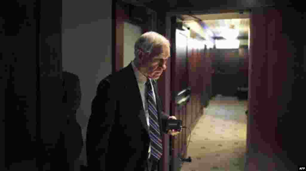 Republican presidential candidate, Rep. Ron Paul, R-Texas walks in a hallway before speaking at a campaign event, Thursday, Dec. 29, 2011, at the Hotel Pattee in Perry, Iowa. (AP Photo/Charles Dharapak)